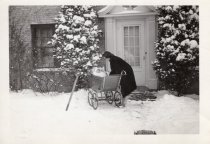 Virginia Shaw with a baby in a carriage at 128 East Witchwood Avenue
